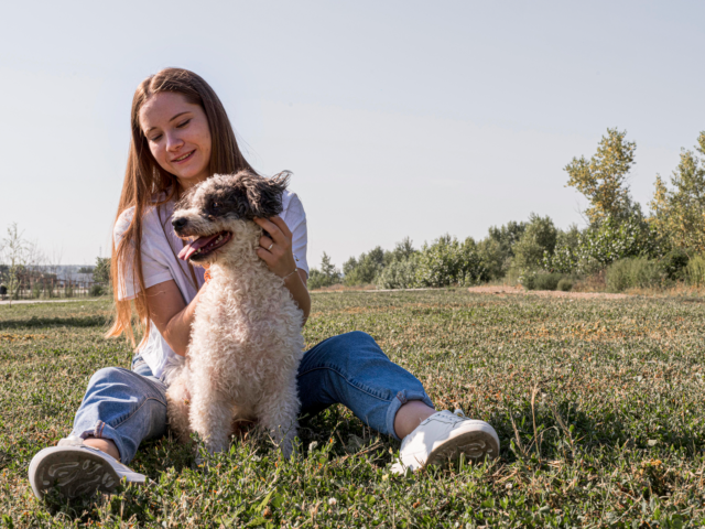 full-shot-smiley-woman-petting-dog